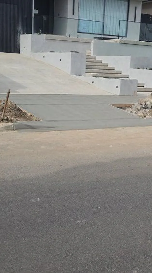 New driveway running up to a home with concrete steps