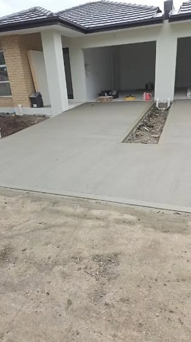 New driveway poured up to the garage of a new home