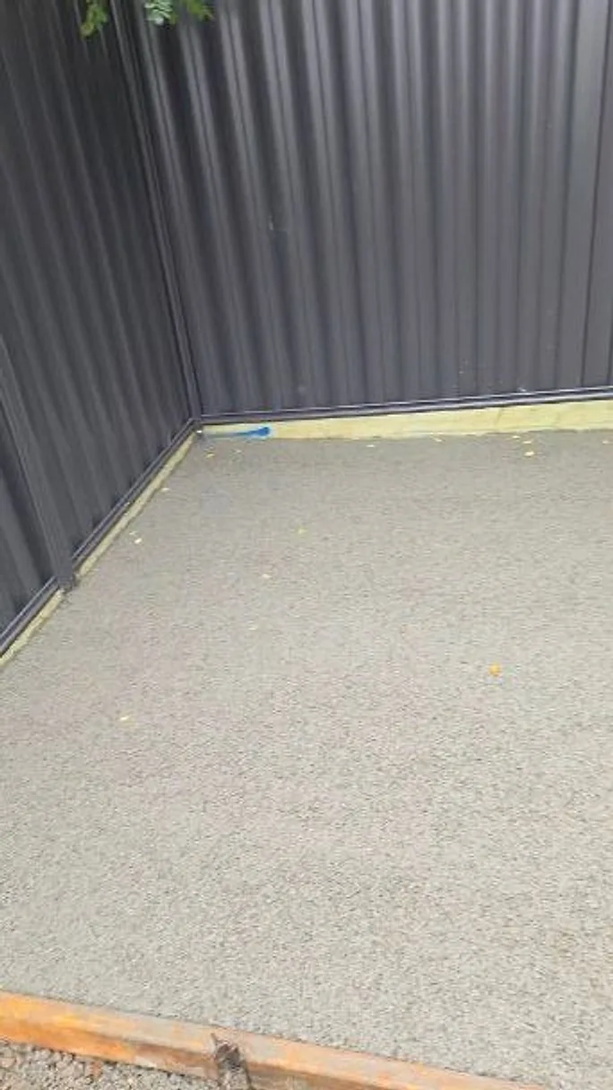 Concrete side path along a Colorbond fence