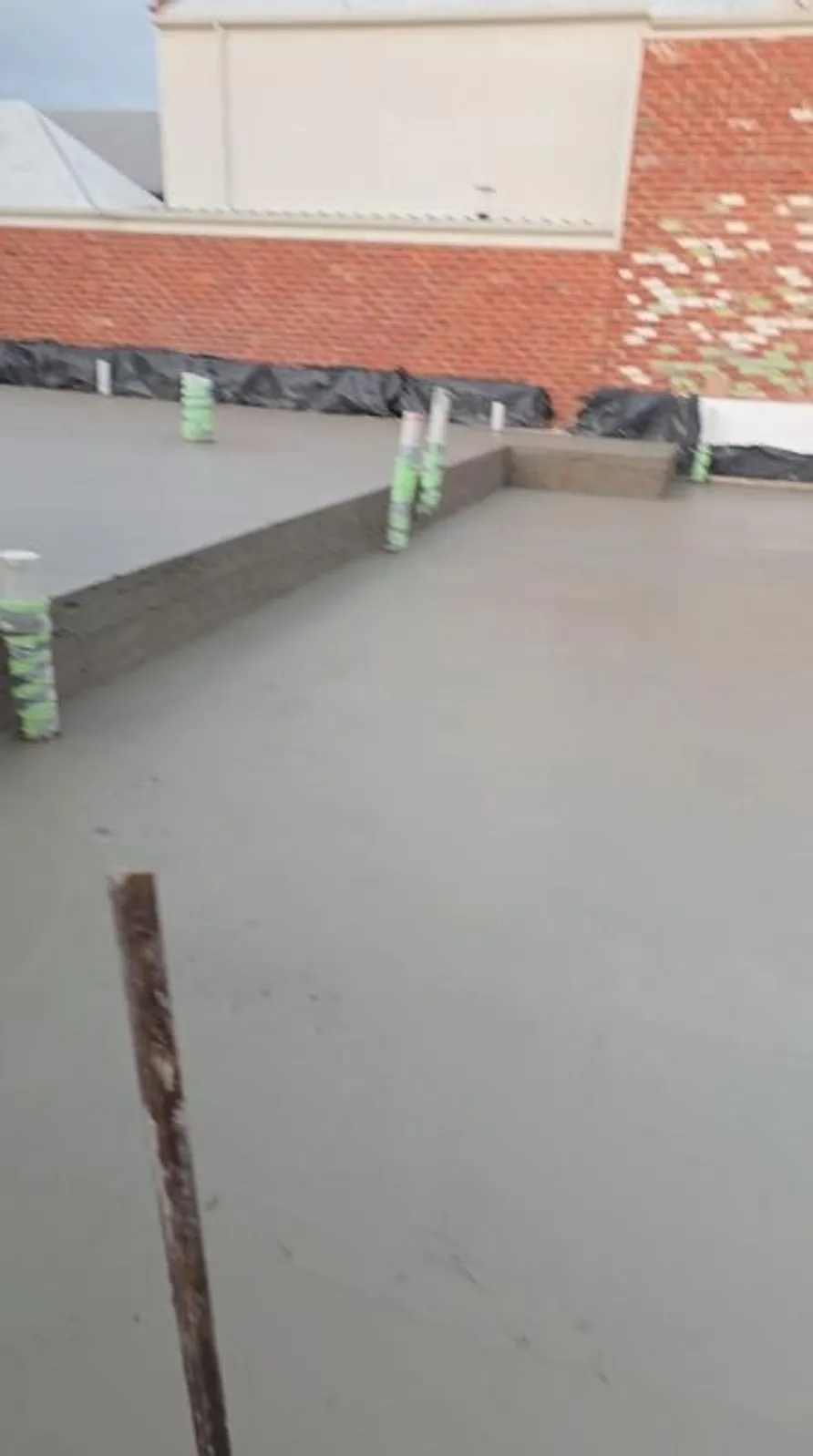 New slab poured up to a brick boundary wall