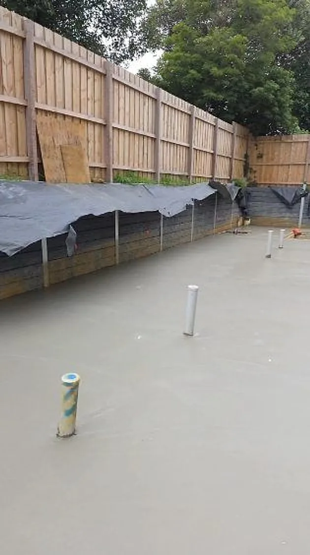 Slab poured with plumbing set in along the fence line